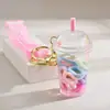 Famoso de Redes Sociales botella de arena movediza taza de té con leche llavero colgante creativo colgante de botella de arena movediza con aceite colgante pequeño para mochila escolar de estudiante
