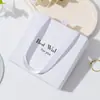 Caja de embalaje caja de aretes caja de collar caja de pulsera caja de anillos bolsa de mano paño para limpiar plata agua para limpiar plata una generación de 001