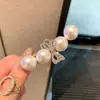 Pinza para el pelo de perlas y lazo de alta gama coreana para arreglar el flequillo y el cabello lateral, pinza de pico de pato para mujer