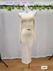 Estilo Europeu e Americano Mais Vendido Top Tricotado com Gola de Uma Linha e Saia Justa Conjunto de Duas Peças Suéter e Saia Cobre-Quadril para Mulheres Outono e Inverno