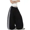 Pantalones de chándal deportivos de retazos a rayas para mujer y hombre, pantalones de baile holgados de pierna ancha para otoño, pantalones versátiles y adelgazantes de largo completo