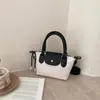 Bolsas de pano Oxford com blocos de cor simples transfronteiriças Bolsa de bolinho Xiangjiao bolsa de mão versátil de nicho bolsa de ombro com textura da moda