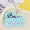 Mini Piano de Mano Llavero Teclado Electrónico Infantil Llavero de Dibujos Animados Colgante Juguete Creativo Toca y Se Ilumina