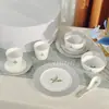 Serie de Lirios del Valle de la Suerte Transfronteriza Juego de Vajilla de Porcelana Hueso Platos, Platos y Tazas Vajilla para el Hogar Simple de Gama Alta Recomendación de Regalo