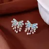 Pendientes de borla con flor de trébol de circonita vintage con un toque de alta gama, pendientes versátiles y de moda al por mayor