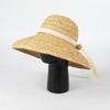 Nuevo sombrero de paja con lazo de rafia de verano europeo y americano, sombrero de playa sencillo a la moda para viajes al aire libre y protección solar.