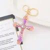 Chaveiro Cruz Olho de Gato da Amazon Pequeno Pingente Criativo Europeu e Americano Strass Metal Anel de Chaveiro para Mochila