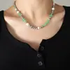 Diseño de nicho estilo Hong Kong cadena para la clavícula marca de moda otoño e invierno cuentas de jade perla de imitación cadena de eslabones cosida joyería de acero de titanio