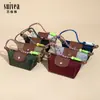 Novo Modelo 2025 Venda Direta da Fábrica Bolsa de Nylon para Dumpling, Pequena e Requintada Bolsa Pequena Multifuncional para Armazenamento de Fones de Ouvido e Batom com Gancho