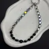 Nuevo cordón para teléfono móvil con cuentas de azúcar de cristal negro de alto valor, llavero para bolso estilo ins, cadena para teléfono móvil
