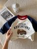 Camiseta Infantil Cartoon Primavera e Outono 2026 Camiseta de Algodão Cartoon para Meninos e Meninas Elegante Color Block Manga Raglan Camiseta Básica Atacado
