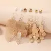 Joyas de gran venta transfronteriza con diseño único, aretes metálicos de hoja hueca para mujer, aretes de borla de alta gama y elegantes