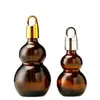 Suministro en stock Botella gotero de plástico con cabeza marrón de calabaza botella secundaria de vidrio transparente para cosméticos botella de loción portátil de viaje