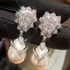Pendientes de Perla y Lirio de Venta Caliente Transfronteriza Nuevo Elegante Ligera Lujo Temperamento Diseño de Moda Pendientes Joyería para Orejas de Mujer