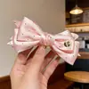 Pinza Plátano Plisada Vertical con Lazo Floral para Cola de Caballo de Verano 2026 Nuevos Pasadores para la Parte Posterior de la Cabeza Accesorios para el Cabello