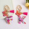 Llavero con borla de mariposa de 26 letras con pegamento de piedra de cristal y 26 letras de Creative Europe y Estados Unidos, joyería colgante.