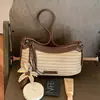 Bolso de mujer tejido a mano de paja de nicho transfronterizo, nuevo modelo de verano 2026 para el trabajo y los desplazamientos, bolso de hombro único, bolso cruzado elegante y moderno