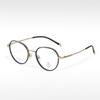 Gafas de montura ovalada pequeña y fresca, pegamento dorado de moda T22055, semi-titanio, se pueden equipar con montura óptica para miopía, anti-luz azul