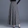 Toma real de la nueva moda femenina para otoño e invierno 2026: falda de lana a cuadros versátil de cintura alta con línea A y dobladillo ancho