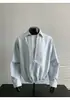 Camisa de Patchwork Rayada para Hombre Nueva Otoño 2026 Falsa de Dos Piezas con Capucha de Solapa Manga Larga Prenda Superior Versátil Exterior