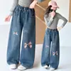 Pantalones infantiles transfronterizos otoño 2026 nuevo estilo jeans holgados para niños niños grandes modernos estampados lavados de pierna ancha