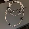 Colección Larga de Collares Superpuestos de Perlas Swarovski para Mujer, Estilo Lujo Ligero, Cadena Versátil para Suéter con un Toque de Alta Gama, Venta al por Mayor Otoño e Invierno
