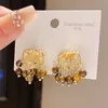Pendientes de Borla con Ojo de Tigre de Circonita de Lujo Ligero Aguja de Plata Estilo Retro Maillard Otoño e Invierno Nicho de Gama Alta para Mujer