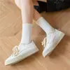 Medias clásicas en blanco y negro y gris para hombre y mujer, de color liso, con cintura antideslizante, de tubo medio, para deportes, informales, transpirables, de algodón.