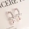 Brincos de Laço Francês com Pérola Rosa de Imitação para Mulheres 2026 Novo Popular Design de Nicho Brincos Modernos e Elegantes