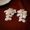 Pendientes de borla de flor de concha blanca transfronterizos europeos y americanos con perlas, pendientes de estilo de corte francés, pendientes ligeros y lujosos con un toque de alta gama