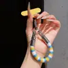 Correa de anillo superestilosa con bloques de color, duradera y resistente con un gancho de metal, un cordón para teléfono anti-pérdida para mujer para ir de compras