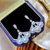 Nueva estética estilo chino, temperamento elegante, diseño de falda abanico, aretes de perlas de agua dulce naturales, aretes estilo corte de alta gama al por mayor