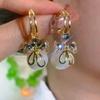 Aretes de Perlas de Lazo Nicho Nuevo Explosiones Zircón Elegante Combinable Moda Personalidad Pin de Plata Aretes Rojos
