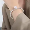 Pulseira estilo antigo estilo chinês costura de contas alto brilho pulseira cruzada galvanoplastia de aço titânio ouro 18K joias por atacado para mulheres