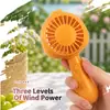 Nuevo modelo de verano, mini ventilador de mano para exteriores e interiores, USB recargable, portátil, de tres velocidades, con base, venta al por mayor