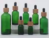 Botellas de vidrio para aceites esenciales con anillo de bambú y madera al por mayor, disponibles en múltiples tamaños, con goteros de goma, adecuadas para aceites esenciales, sueros y como botellas dispensadoras de cosméticos portátiles