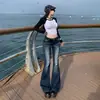 Estilo retro americano 2026, cintura baixa, versátil, caimento justo, jeans boca de sino outono/inverno para mulheres, calça comprida, disponível para drop shipping