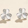 Elegantes aretes de trébol de moda 2023 nueva tendencia aretes giratorios de hierba de tres hojas incrustados de diamantes