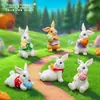 Nuevo producto transfronterizo: Lindo peluche de conejo sosteniendo un huevo de Pascua, accesorios de decoración DIY, mini adornos colgantes