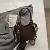 Bolsa de ombro com padrão trançado 2026 novo estilo, toque relaxado, bolsa tipo saco de cor sólida, alto valor estético, versão coreana simples, bolsa transversal para o dia a dia
