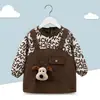 Babero de terciopelo de cristal para bebé, impermeable, antidesgaste, con bolsillo de arroz, para otoño e invierno, delantal para madre y bebé.