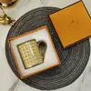 Taza de Cerámica Hueso Marca H Caballo Dorado Tirando de Carruaje Mango Dorado para Hogar Oficina Taza de Agua Pareja Emparejamiento Venta al por Mayor