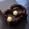 Accesorios para el cabello coreanos al por mayor máscara de perlas de alta gama anillo intestinal cuerda para el cabello de mujer banda de goma gruesa cabeza de bola funda de cuero