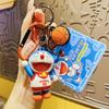 Llavero auténtico de Doraemon con diseño de experto deportivo, colgante creativo de mochila escolar con dibujo de coche, regalo pequeño para pareja, venta al por mayor