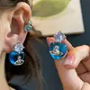 Brincos Saturno Coração Azul Zircônia para Mulheres Design de Nicho Sexy de Alta Qualidade Brincos de Clipe para Cartilagem Auricular Planeta Elegante para Mulheres