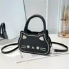 2026 Verano Nuevo Elegante Lindo Gato Dibujos Animados Femenino Simple Versátil Moderno Bolso de Hombro Cruzado Bolso de Mano