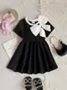 Comercio exterior transfronterizo Verano europeo y americano 26 nuevos modelos de elegantes vestidos de princesa negros con cuello redondo y lazo para bebés y niños pequeños, directo del fabricante