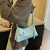 Textura de nicho color retro bloque de color lunares 2026 otoño nuevo elegante simple gran capacidad versátil bolso de hombro cruzado