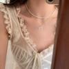 Collar con perlas y lazo de diamantes de imitación de estilo coreano para mujer, cadena elegante con diseño de nicho de lujo y luz.