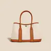 Bolsa de Jardim em Lona e Couro de Couro Genuíno 2026 Nova Bolsa Tote de Grande Capacidade Bolsa de Mão Casual Colorida e Bolsa Transversal
